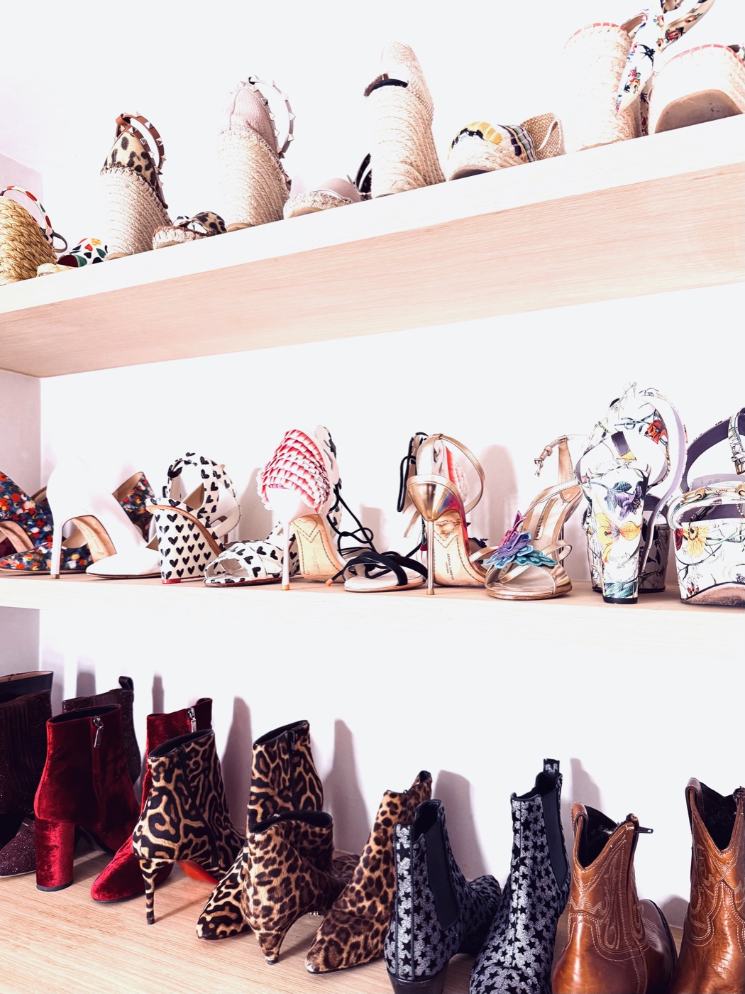 Women's heels, espadrilles, and boots beautifully arranged on shelves