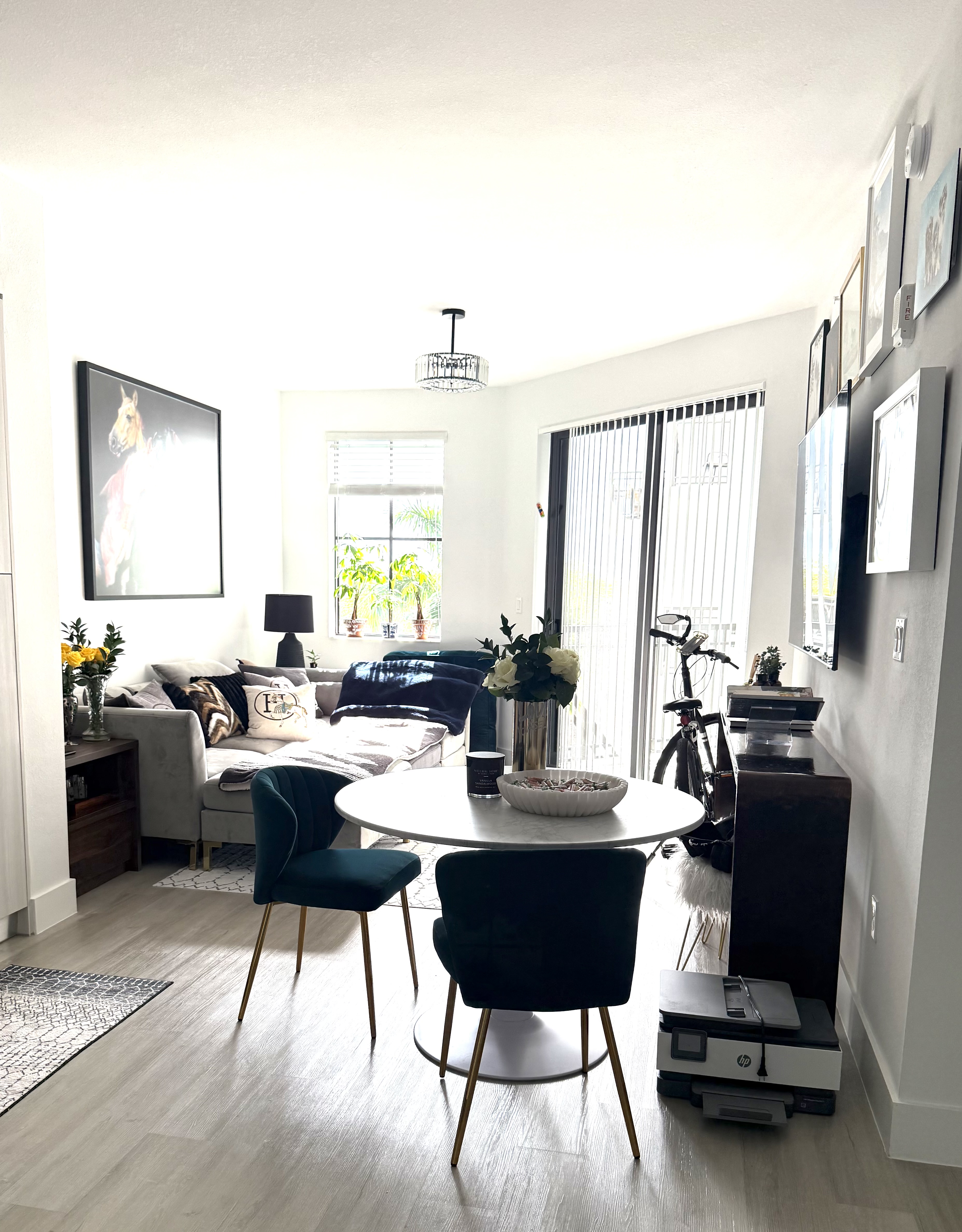 Living and dining area styled and organized with a curated gallery wall