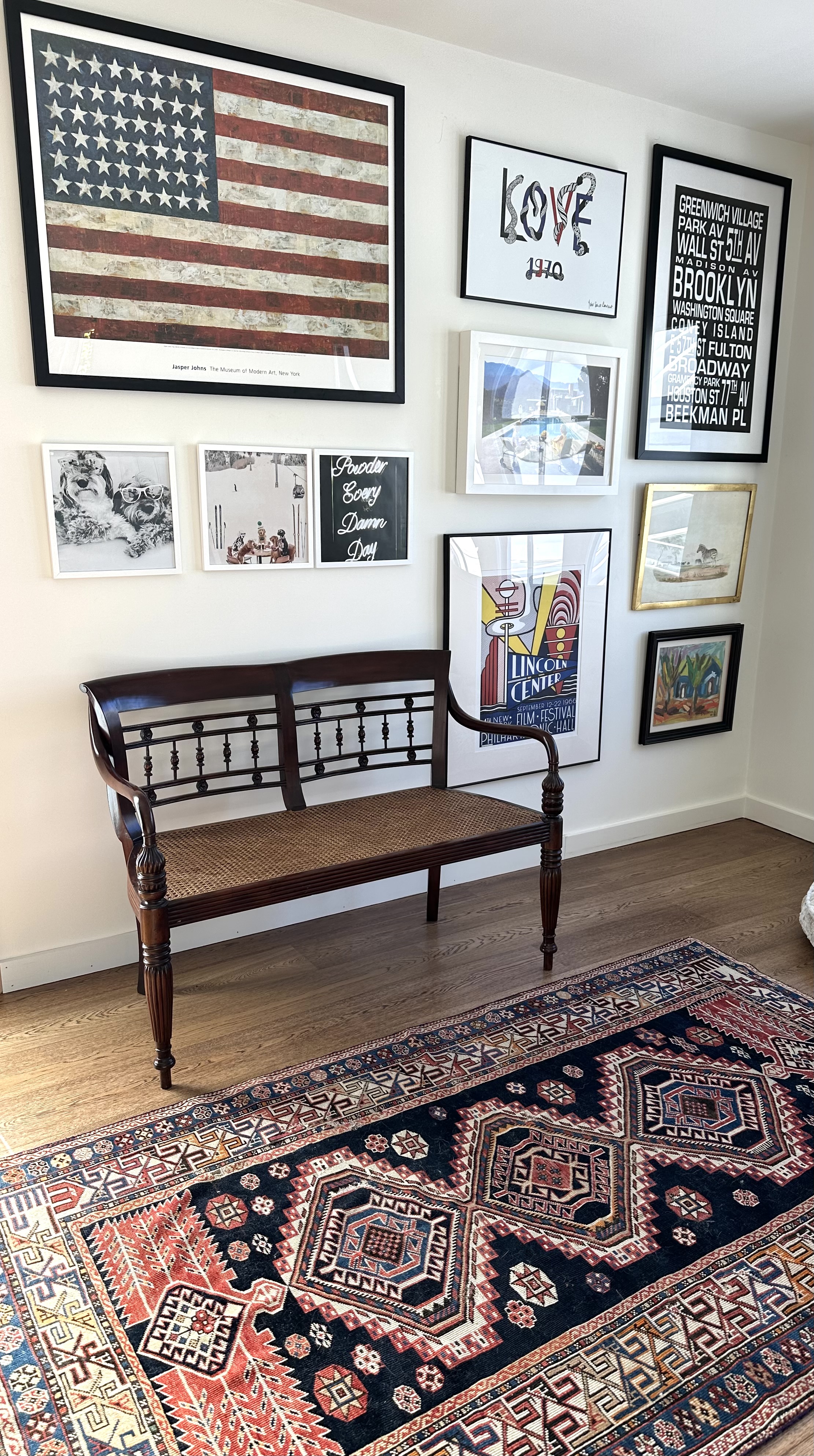 Styled gallery wall and reading bench in a home office nook